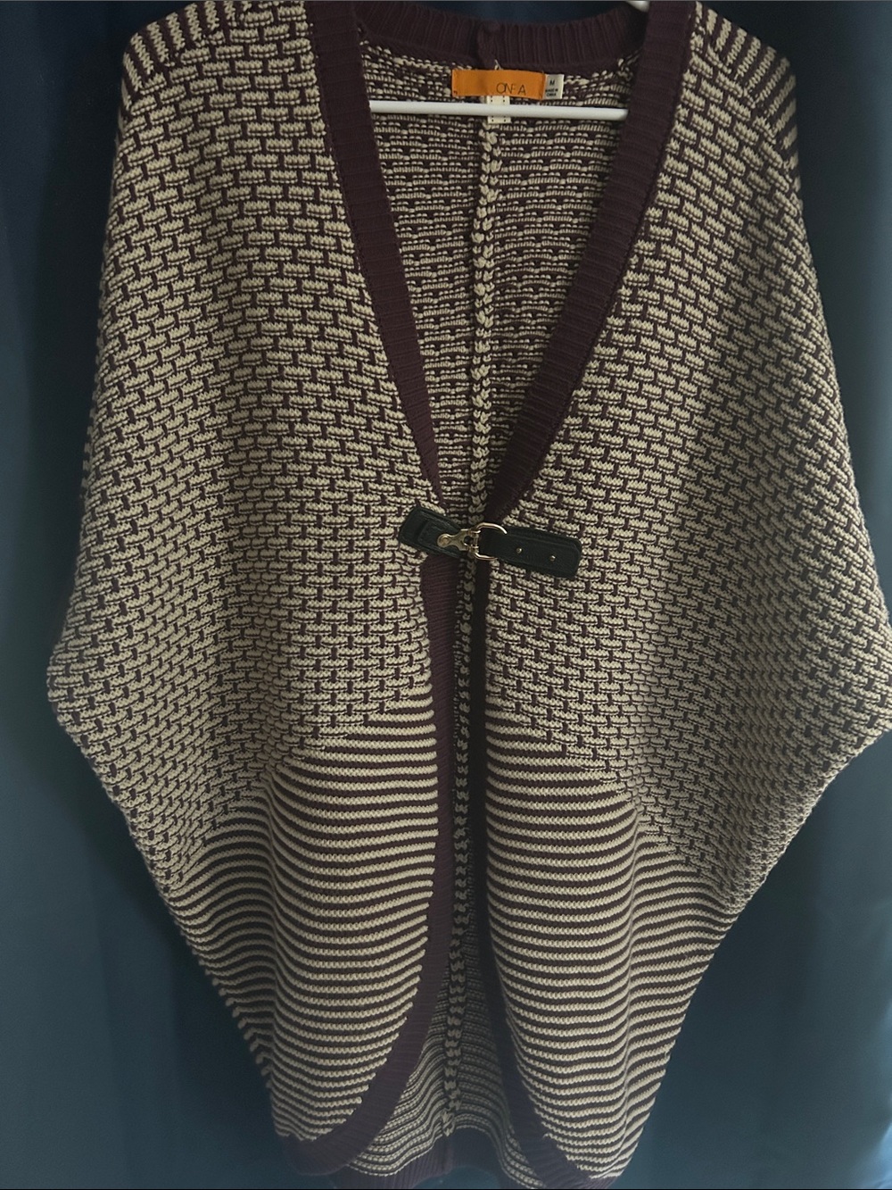 One A Cream and Brown Knit Poncho with Decorative Clasp